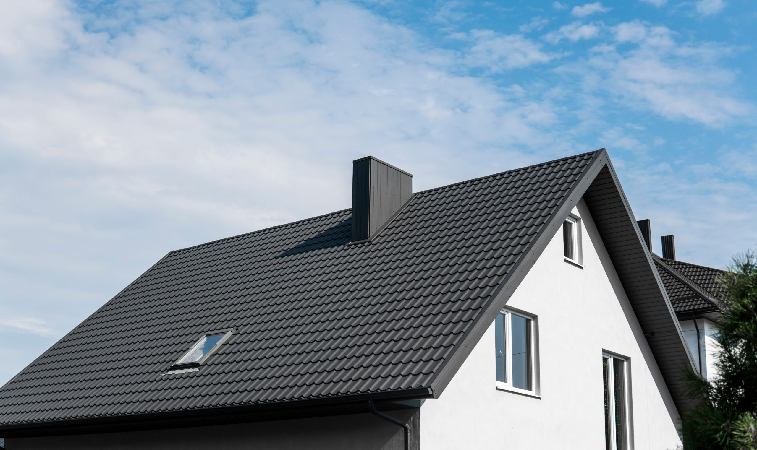Modern roof covered with tile effect PVC coated brown metal roof sheets.